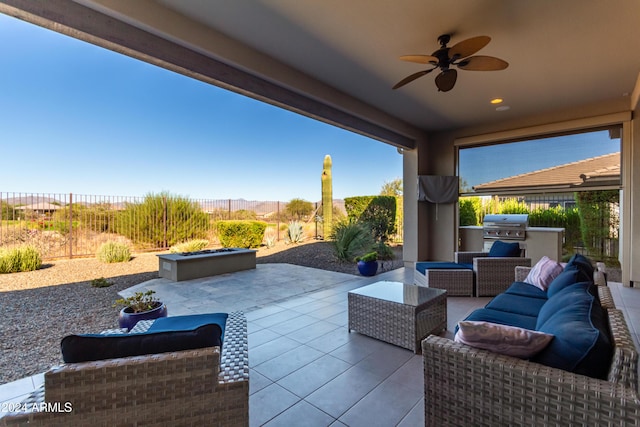 17756 E Silver Sage Ln, Rio Verde, AZ 85263 - view of patio with an outdoor hangout area, exterior kitchen, ceiling fan, a fenced backyard, and grilling area