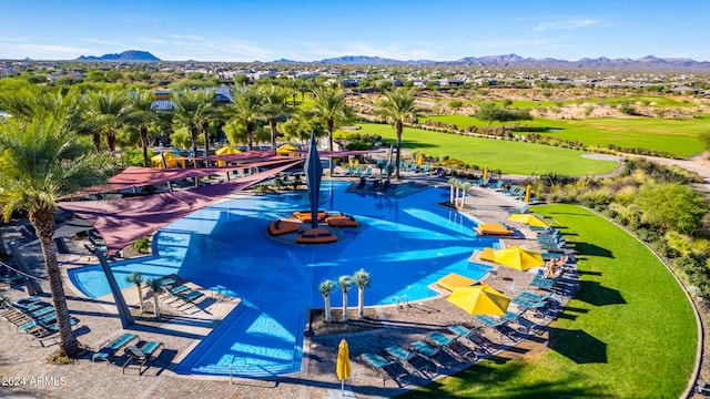 exterior space featuring a patio, a mountain view, and a swimming pool