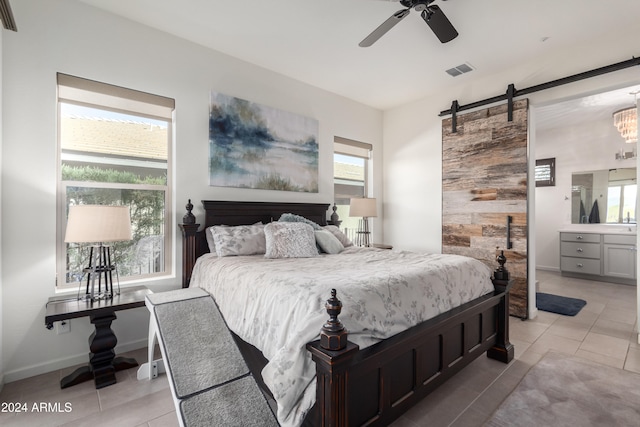 tiled bedroom featuring multiple windows, ensuite bathroom, and ceiling fan