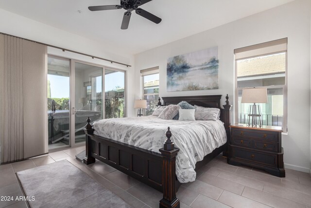 bedroom with access to outside, multiple windows, light tile patterned floors, and ceiling fan