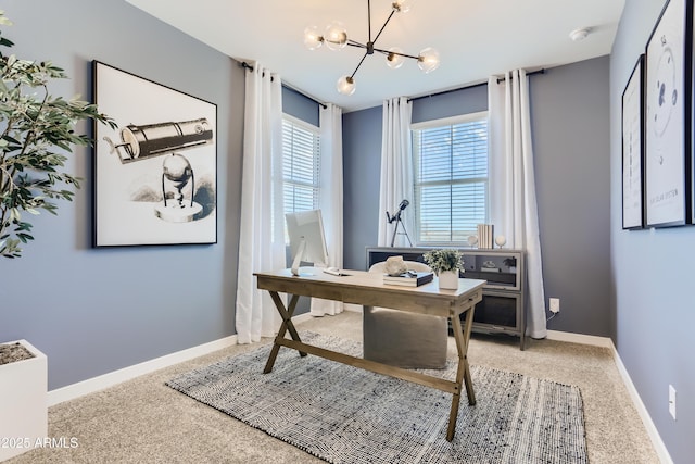 home office with a chandelier, carpet floors, and baseboards