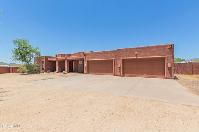 pueblo-style home with a garage