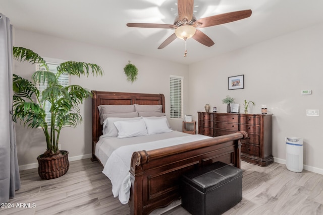 bedroom with ceiling fan and light hardwood / wood-style floors