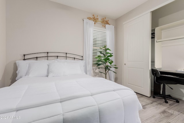 bedroom featuring light wood-type flooring and a closet