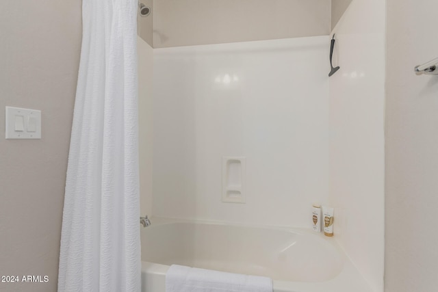 bathroom featuring shower / bathtub combination with curtain