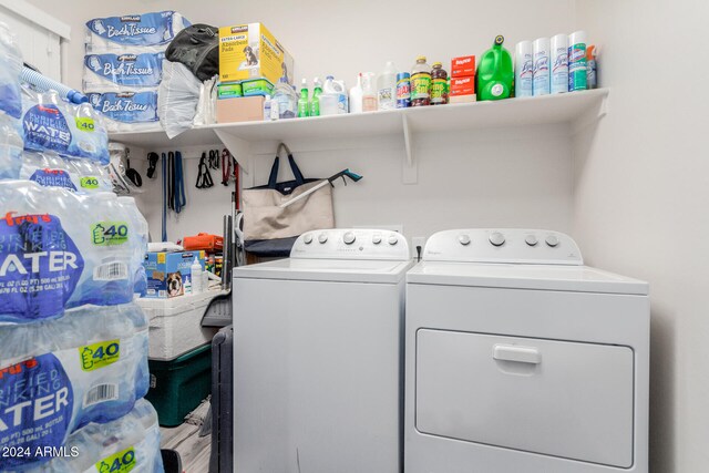 washroom with hardwood / wood-style floors and separate washer and dryer