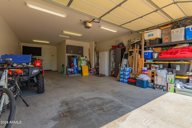 garage with water heater, a garage door opener, and fridge