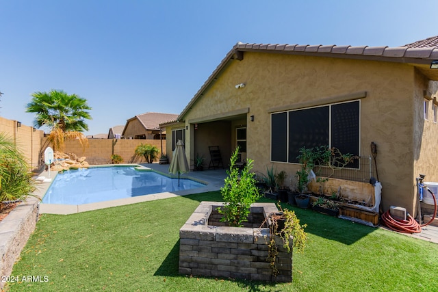 view of swimming pool featuring a lawn and a patio area