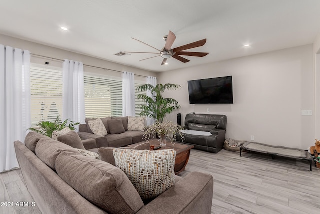 living room with ceiling fan and light hardwood / wood-style flooring