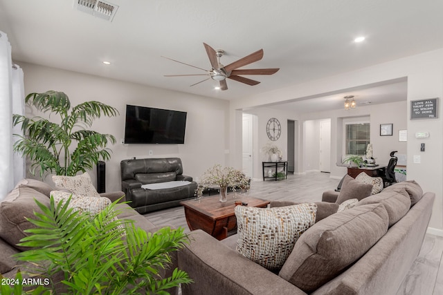 living room featuring ceiling fan and light hardwood / wood-style flooring