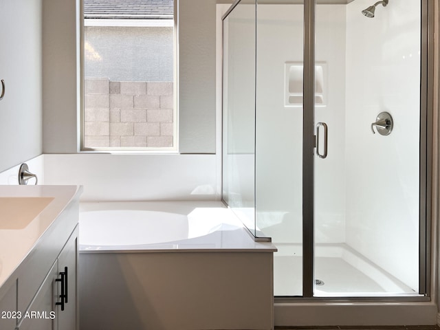 bathroom featuring separate shower and tub and vanity