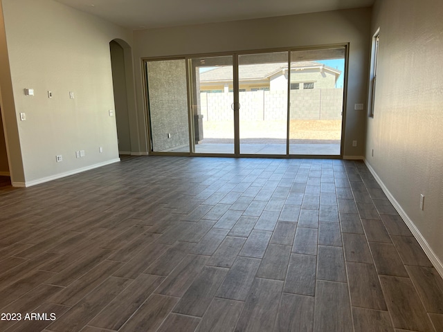 unfurnished room with dark hardwood / wood-style floors