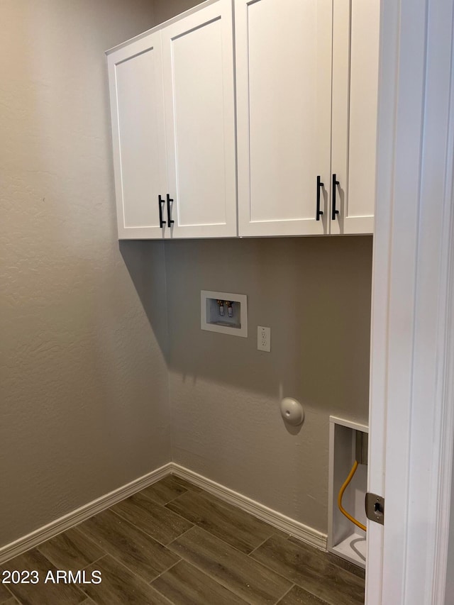 laundry room with washer hookup, cabinets, and dark hardwood / wood-style floors