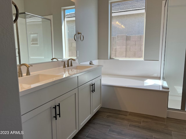 bathroom featuring separate shower and tub, hardwood / wood-style flooring, and vanity