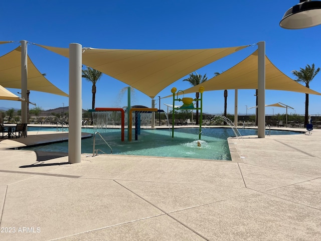 view of swimming pool with a patio area and pool water feature