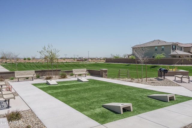 view of home's community with a lawn and a patio area