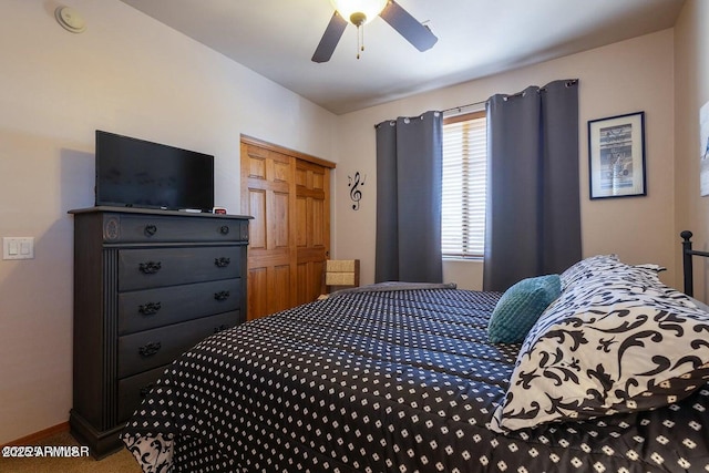 carpeted bedroom with ceiling fan and a closet