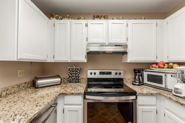 2941 N Oregon St Unit 12, Chandler, AZ 85225 - kitchen featuring electric stove, under cabinet range hood, white microwave, white cabinetry, and light stone counters