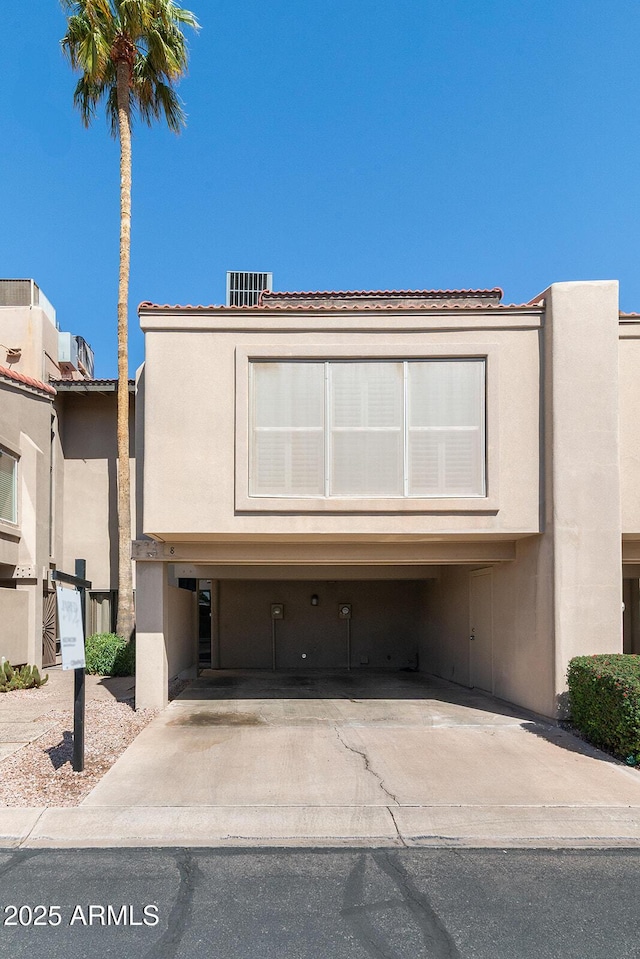 view of front facade featuring concrete driveway and stucco siding