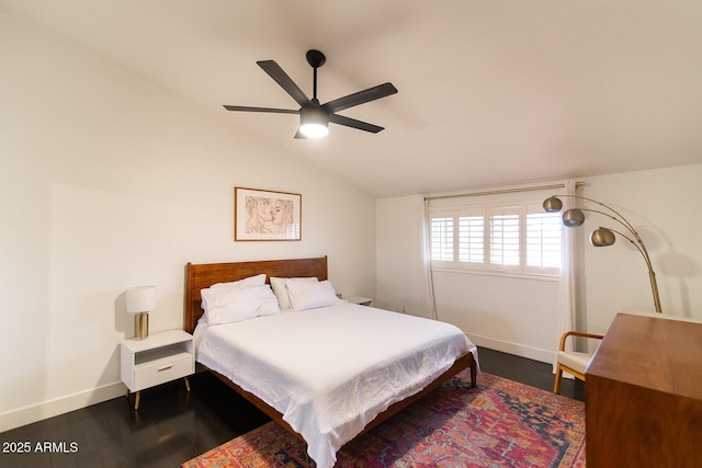 bedroom featuring ceiling fan, wood finished floors, baseboards, and vaulted ceiling