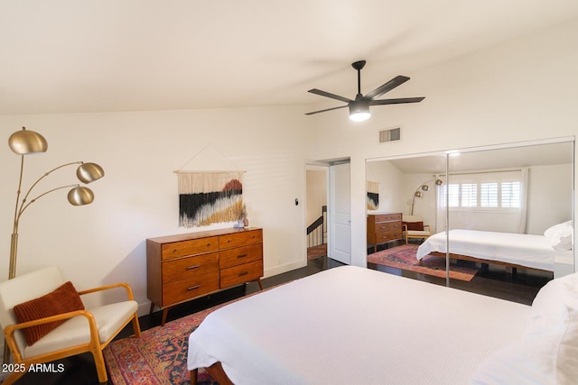 bedroom with visible vents, lofted ceiling, a closet, and a ceiling fan