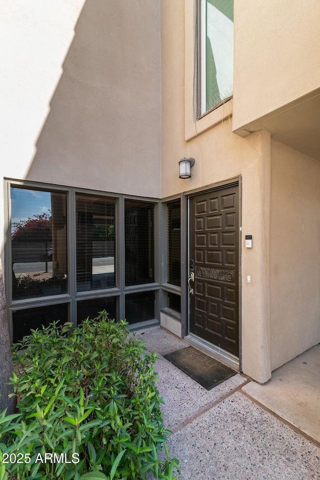 doorway to property with stucco siding