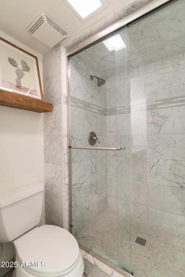 full bathroom featuring toilet, visible vents, and a stall shower