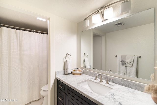 bathroom with a shower with shower curtain, visible vents, toilet, and vanity