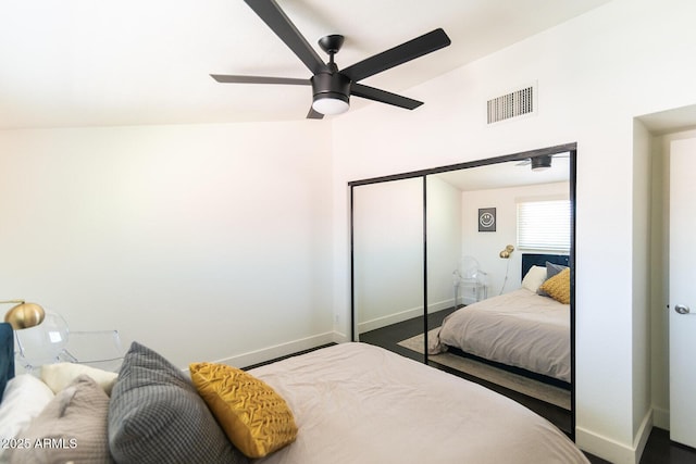 bedroom featuring a closet, visible vents, ceiling fan, and baseboards