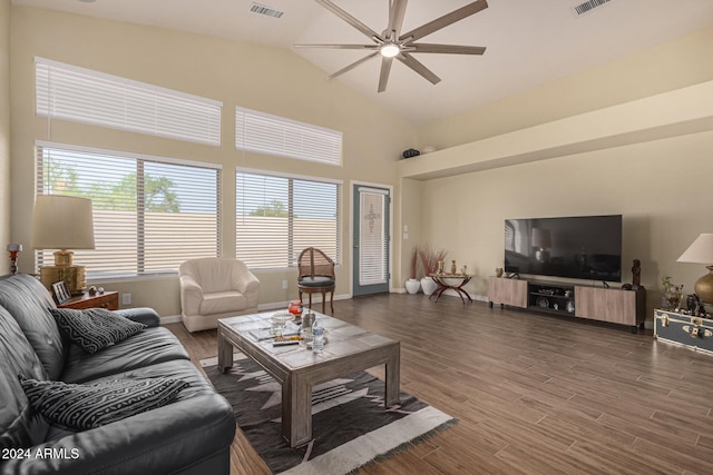 living room featuring dark hardwood / wood-style floors, high vaulted ceiling, and ceiling fan