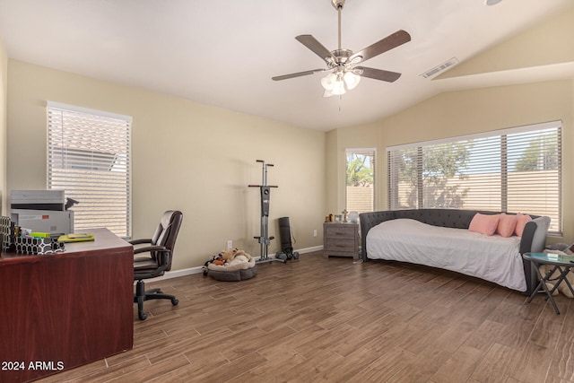 bedroom with ceiling fan, hardwood / wood-style flooring, and lofted ceiling