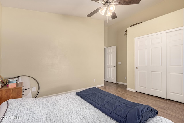 bedroom with light hardwood / wood-style flooring, a closet, and ceiling fan