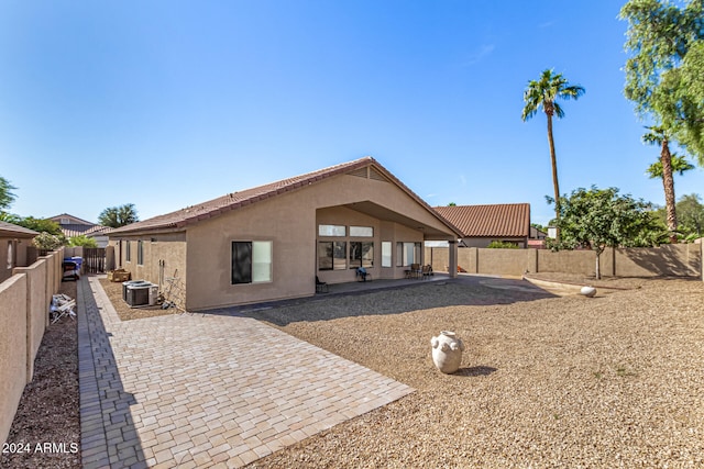 back of property featuring central air condition unit and a patio area