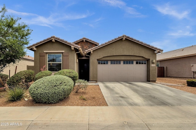 1725 E Chanute Pass, Phoenix, AZ 85040 - view of front of house featuring a garage, driveway, stucco siding, and a tile roof