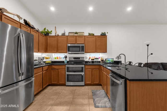 1725 E Chanute Pass, Phoenix, AZ 85040 - kitchen featuring stainless steel appliances, a sink, brown cabinetry, a peninsula, and recessed lighting