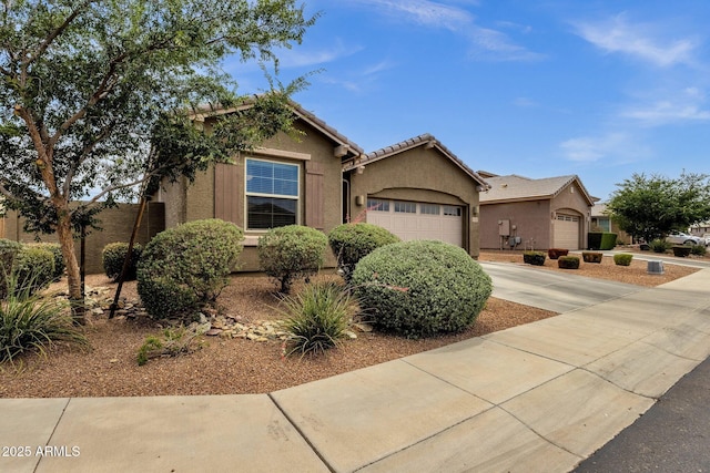 1725 E Chanute Pass, Phoenix, AZ 85040 - view of front facade with driveway, a garage, stucco siding, and a tiled roof