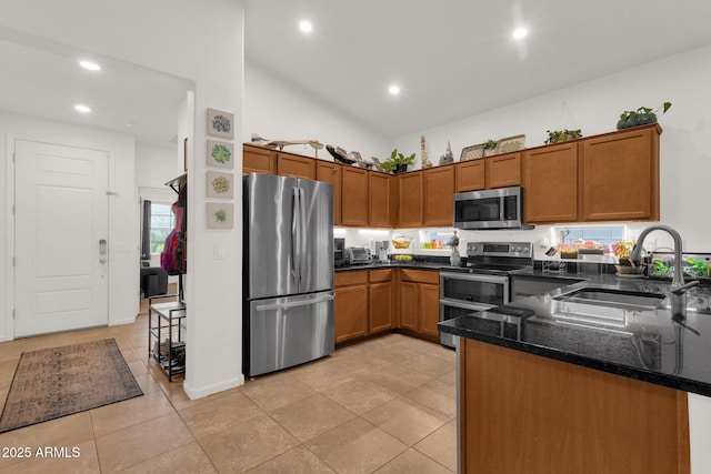 1725 E Chanute Pass, Phoenix, AZ 85040 - kitchen with appliances with stainless steel finishes, a sink, brown cabinets, dark stone counters, and recessed lighting