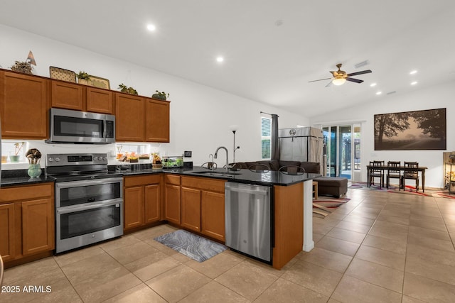 1725 E Chanute Pass, Phoenix, AZ 85040 - kitchen featuring stainless steel appliances, a sink, brown cabinets, vaulted ceiling, and ceiling fan
