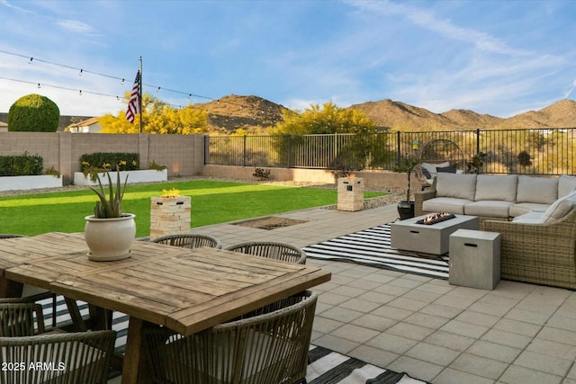 27203 N 78th Ln, Peoria, AZ 85383 - view of patio featuring an outdoor living space with a fire pit, a mountain view, and a fenced backyard