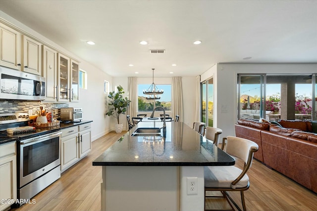 27203 N 78th Ln, Peoria, AZ 85383 - kitchen featuring light wood-style flooring, cream cabinetry, visible vents, appliances with stainless steel finishes, and a sink