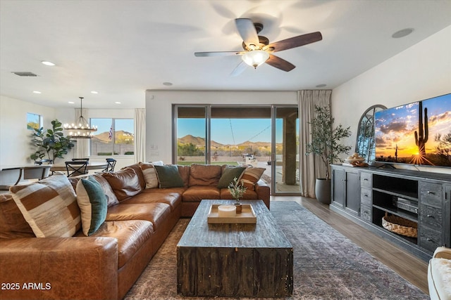27203 N 78th Ln, Peoria, AZ 85383 - living area featuring ceiling fan with notable chandelier, wood finished floors, visible vents, and recessed lighting