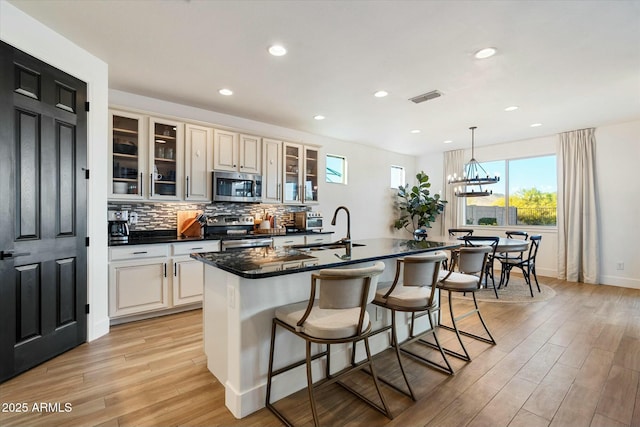 27203 N 78th Ln, Peoria, AZ 85383 - kitchen with visible vents, plenty of natural light, a sink, dark countertops, and stainless steel appliances
