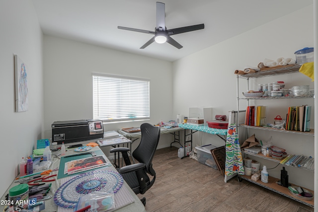 home office with light wood-type flooring and ceiling fan