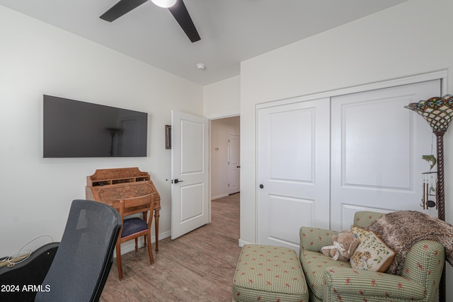 home office with ceiling fan and light wood-type flooring