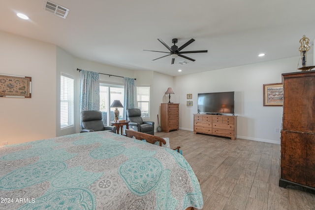 bedroom with light hardwood / wood-style flooring and ceiling fan