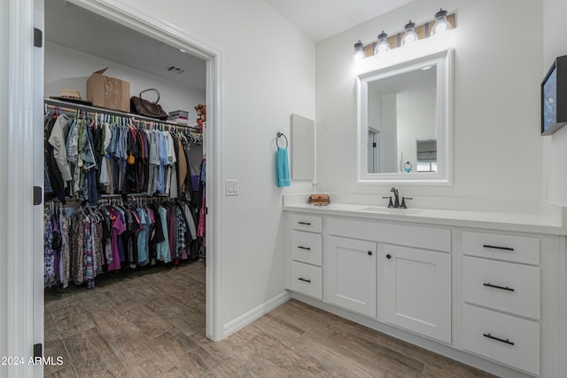 bathroom with vanity and wood-type flooring