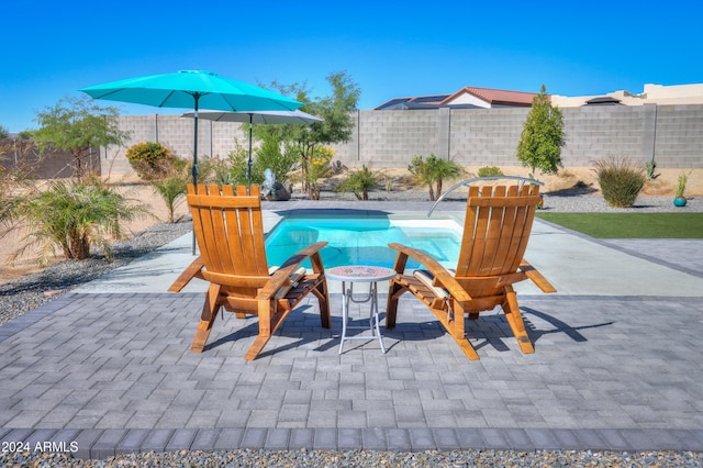 view of patio with a fenced in pool