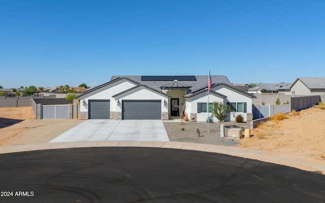 view of front of home with solar panels and a garage