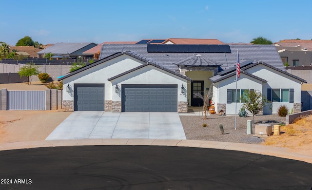 view of front of home with solar panels and a garage