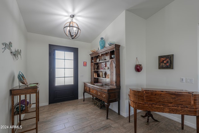 entrance foyer featuring hardwood / wood-style flooring and an inviting chandelier